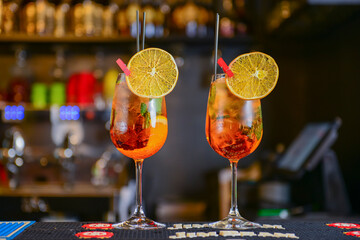 Two cocktails with ice in glasses on a bar. Party, celebration, hight club.