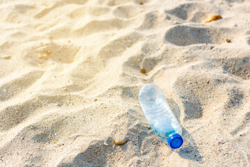 Fototapeta na wymiar Top view Plastic water bottles on the beach by the sea.
