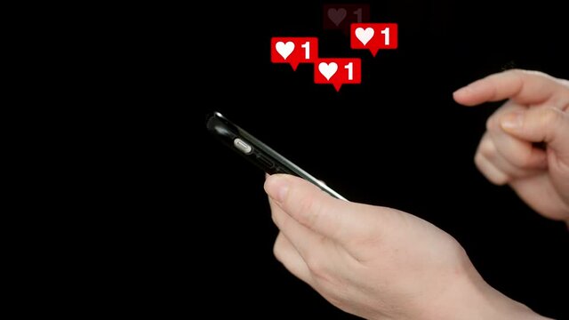 Internet user voting in social networks by like icon. Female hand holding smartphone and pushing to screen for likee in heart shape in social networks.