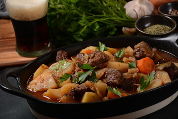 Irish stew made with beef, potatoes, carrots and herbs. Traditional St.Patrick's day dish, stewed in dark Guinness beer