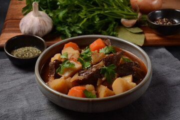 Irish stew made with beef, potatoes, carrots and herbs. Traditional St.Patrick's day dish, stewed in dark Guinness beer