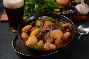 Irish stew made with beef, potatoes, carrots and herbs. Traditional St.Patrick's day dish, stewed in dark Guinness beer