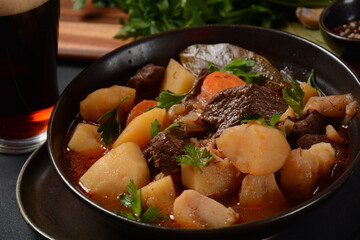 Irish stew made with beef, potatoes, carrots and herbs. Traditional St.Patrick's day dish, stewed in dark Guinness beer