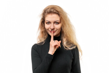 Close up blonde girl keeping finger at her mouth, saying Shh, Hush, Tsss. Silence and secret concept, isolated