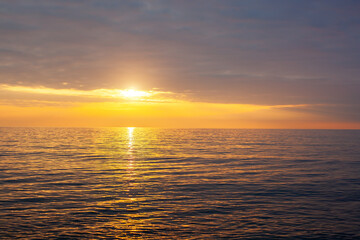 Naklejka na ściany i meble Amazing beach sunset with endless horizon. Horizontal. Selective focus.