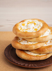 stacked cheesecakes with cream filling closeup, traditional russian or ukrainean buns with curd cream and pieces of fruit, healthy nutrition