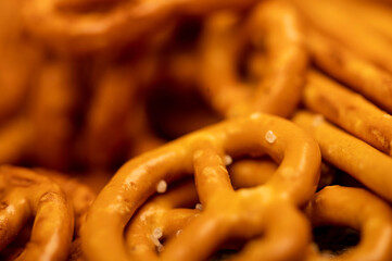 Salted breadsticks and salted pretzels scattered on the table.