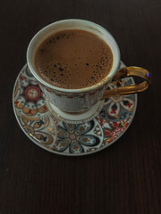 Traditional Turkish coffee cup with wooden background