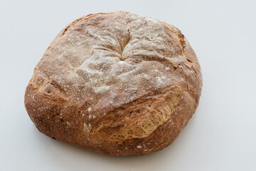 Freshly baked traditional bread on white table
