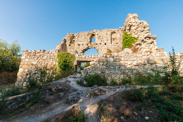Fototapeta na wymiar Mangup-Kale is an ancient cave town in Crimea. View of antique citadel ruins at sunset.