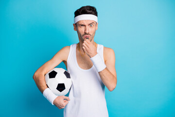 Photo of angry soccer player hold ball blow whistle wear white tank-top isolated over blue color...