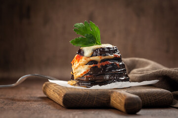 Parmigiana di melanzane - italian dish, deep fried eggplants baked with mozzarella, parmezan cheese...