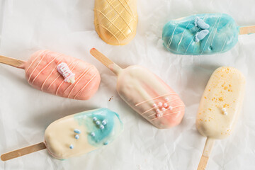 Fototapeta na wymiar Collored Ice Cream Bar on a Stick, pink, blue, yellow, wedding, brown 