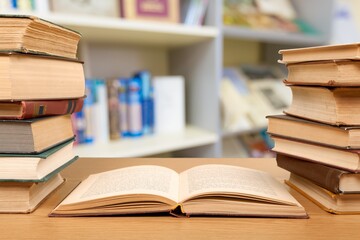 Stack open old books on wooden desk