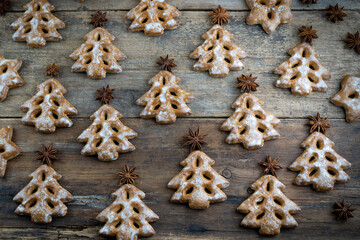 Christmas cookies in the shape of a Christmas tree. New Year's food. Anise star. Festive baked goods. Gingerbread on the table. Pattern