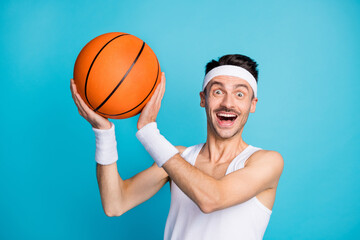 Photo of young excited man happy positive smile hold ball player goal isolated over blue color background