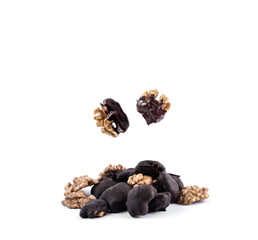 Walnuts in chocolate, a bunch of peeled walnuts with half and whole walnut isolated on a white background.