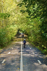 People walk in the city park in autumn.