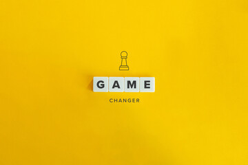 Game Changer Concept and Banner. Block Letters and Pawn Icon on Bright Orange Background.