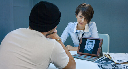 A female detective shows the irrefutable evidence of the crime on the screen