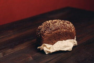 a loaf of rye bread on paper coasters and a board in the background of a wooden table