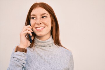 Young irish teenager girl smiling happy talking on the smartphone at the city.