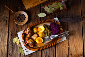 Rustic Snirtjebraten with red cabbage and cucumber