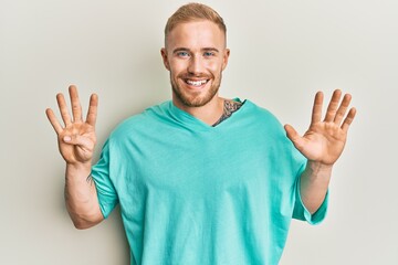 Young caucasian man wearing casual clothes showing and pointing up with fingers number nine while smiling confident and happy.