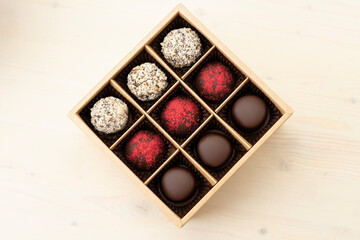 Luxury assorted chocolates in gift box. Handmade candy in an open box on white background