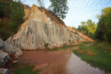 Sandy cut along the stream. Asian nature.
