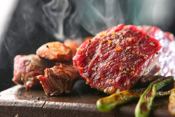 Raw beef dishes being cooked on a fire plate 불판위에 조리되고 있는 생소고기 요리