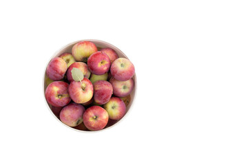 Red apples with green leaves in bucket isolated on white background. Top view