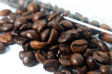 Coffee beans close to the test tube In the test tube