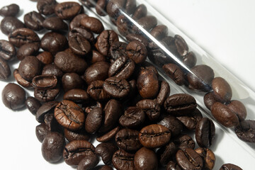 Coffee beans close to the test tube In the test tube
