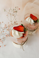 pudding garnished with strawberries and cream on the table