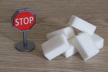 Heap of sugar cubes and stop road sign - 422257966