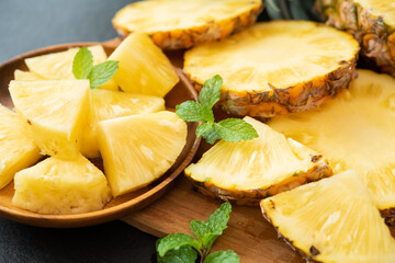 Whole and sliced pineapple on the wooden texture background. .have a lot of fiber,vitamins C and minerals. food, fruits or healthcare concept.