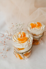 pudding in a glass decorated with a slice of tangerine on the table