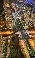 Aerial view of Bangkok city at night in Thailand. cityscape of Modern buildings, urban architecture and road traffic