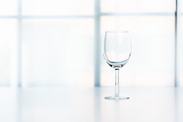 A transparent glass of water is placed on the table in the house on a white background.