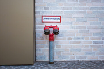Fire water supply with two outlets is located at a building.