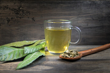 medicinal infusion of loquat leaves with honey, on rustic wooden background
