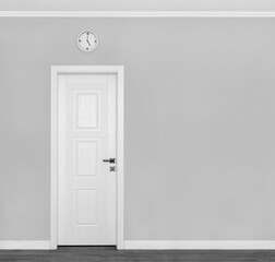 Grey wall with white door and clock. Traditional afternoon tea  symbols of England. Concept or creative idea that means tea time.