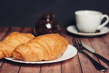 croissants white plates on the table kitchenware a cup 