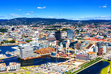 Fototapeta na wymiar Oslo, Norway. Aerial view of Sentrum area of Oslo, Norway, with Barcode buildings and the river Akerselva. Construction site with blue sky during a sunny summer day