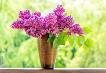  Bouquet purple (Violet) Lilac Flower  in a brown vase. Syringa vulgaris (common lilac). Spring flowers..