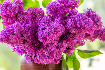  Bouquet purple (Violet) Lilac Flower  in a brown vase. Syringa vulgaris (common lilac). Spring flowers..