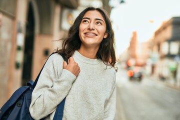 Young middle east student girl smiling happy standing at the city.