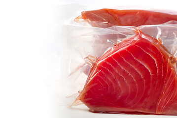 Frozen Tuna steak vacuum with ice on the counter the fishmarket. healfy food and nutrition concept