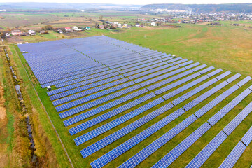 Fototapeta na wymiar Aerial view of solar power plant on green field. Electric farm with panels for producing clean ecologic energy.